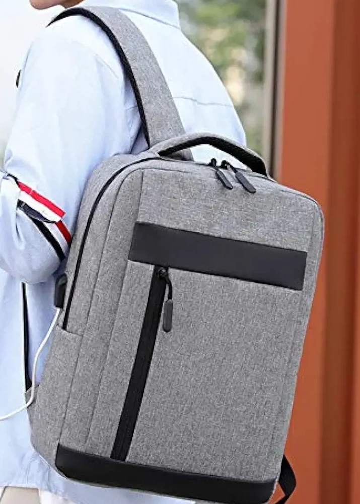 USB Charging Laptop Backpack with multiple compartments, laptop storage section and external USB charging port available in black, blue, grey and red colors.
