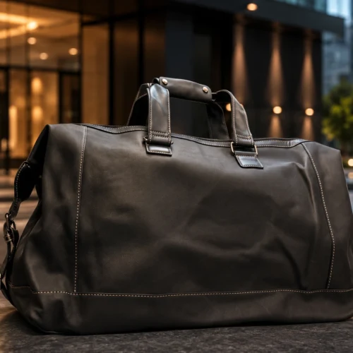 Premium Leather Travel Duffel Bag in black featuring spacious storage, reinforced handles, detachable shoulder strap and luxury travel design.